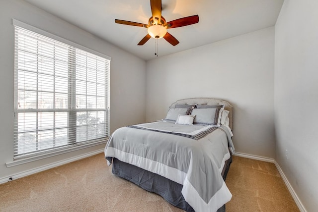 bedroom with a ceiling fan, carpet, and baseboards