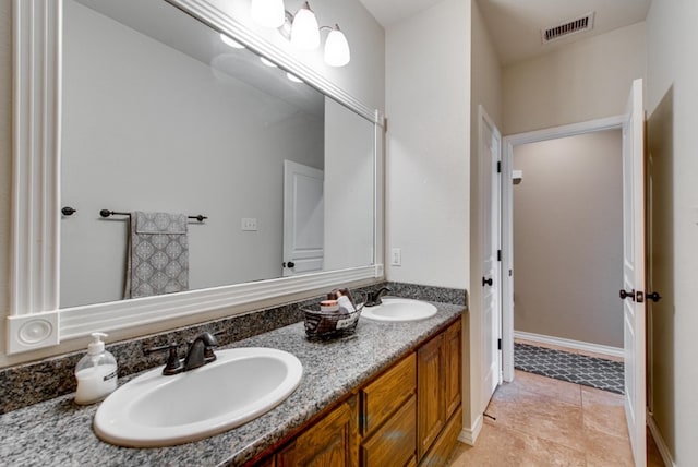 full bathroom with double vanity, a sink, visible vents, and tile patterned floors