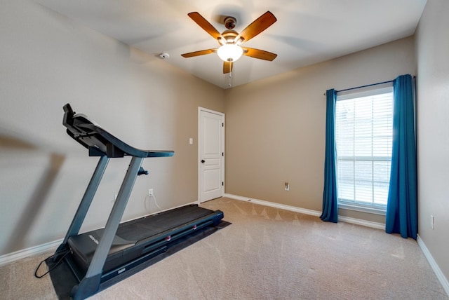 workout room featuring a ceiling fan, carpet flooring, and baseboards