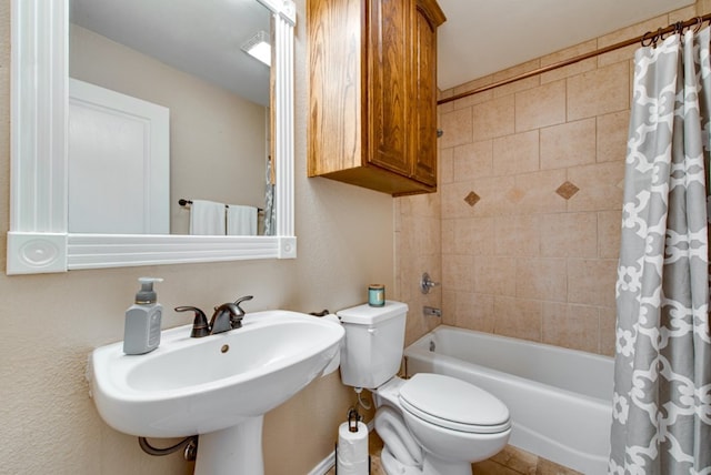 full bathroom featuring shower / bath combo, a sink, and toilet