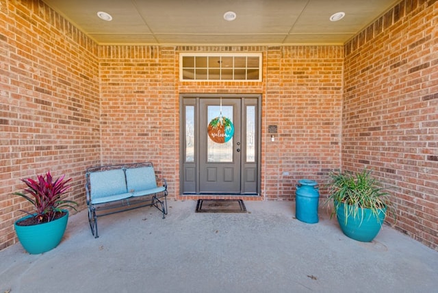 view of exterior entry with brick siding