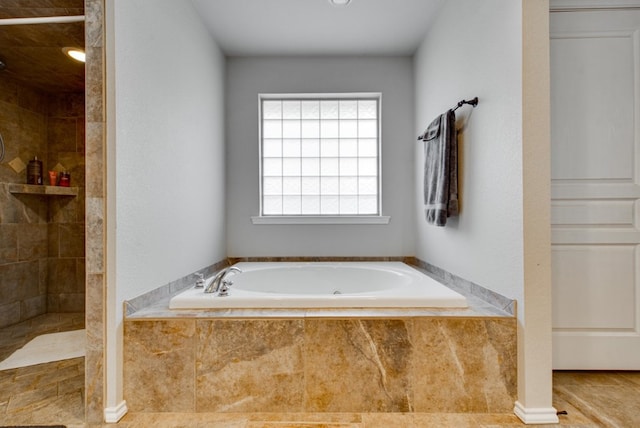 full bathroom featuring tile patterned flooring, a garden tub, and a tile shower