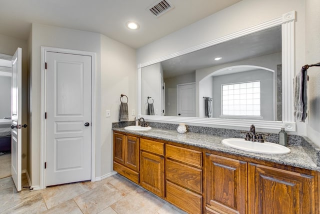 full bath with double vanity, visible vents, a sink, and recessed lighting