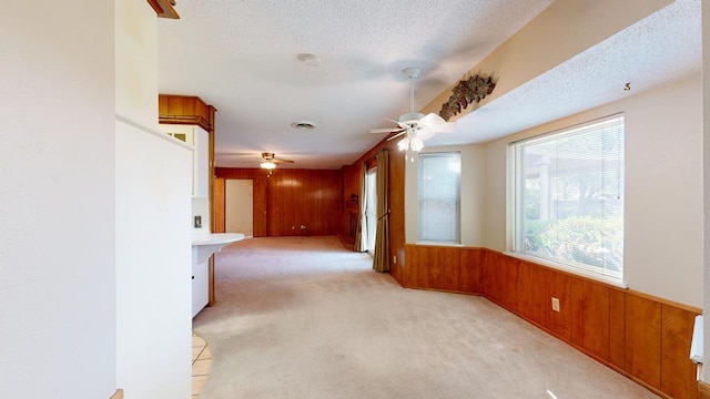 3525 Stanolind Ave, Midland, TX 79707 - empty room with ceiling fan, wood walls, light carpet, and a wainscoted wall