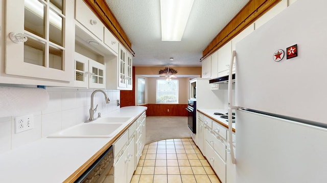 3525 Stanolind Ave, Midland, TX 79707 - kitchen with white appliances, light carpet, light countertops, white cabinets, and light tile patterned flooring