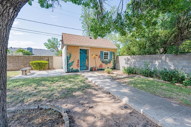 3525 Stanolind Ave, Midland, TX 79707 - bungalow-style home with concrete block siding, a fenced backyard, a patio area, an outbuilding, and a shingled roof