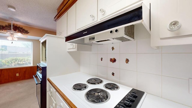 3525 Stanolind Ave, Midland, TX 79707 - kitchen featuring under cabinet range hood, ceiling fan, light countertops, white cabinetry, and backsplash