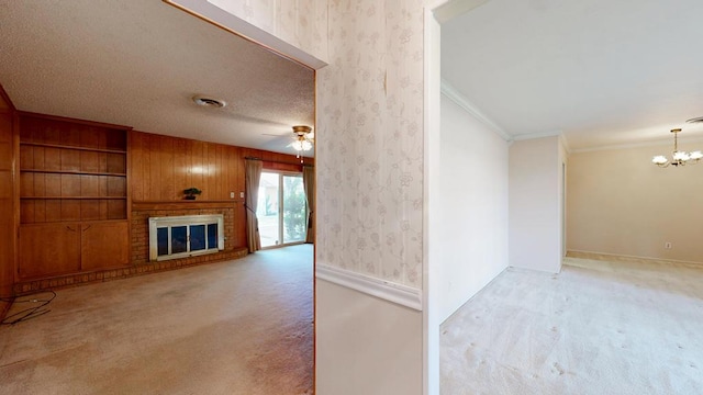 3525 Stanolind Ave, Midland, TX 79707 - unfurnished living room with light colored carpet, a chandelier, a fireplace, crown molding, and ceiling fan