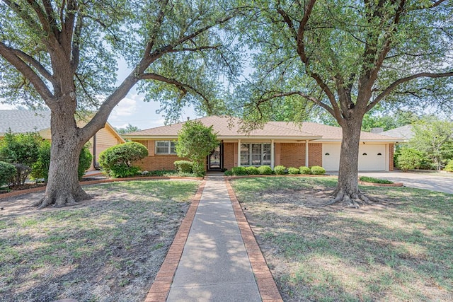 3525 Stanolind Ave, Midland, TX 79707 - single story home with a garage, concrete driveway, and brick siding