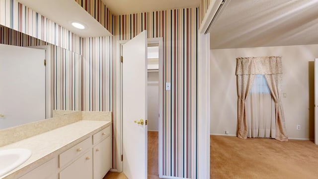 3525 Stanolind Ave, Midland, TX 79707 - bathroom with wallpapered walls and vanity