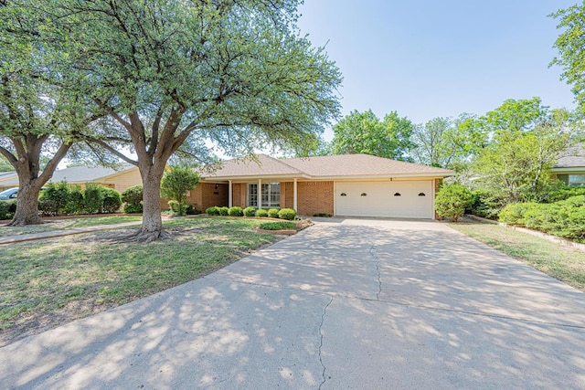 3525 Stanolind Ave, Midland, TX 79707 - ranch-style home with a garage, driveway, and brick siding