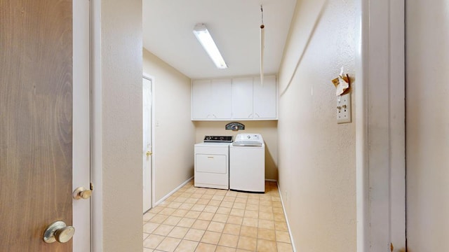 3525 Stanolind Ave, Midland, TX 79707 - laundry area featuring washing machine and clothes dryer, cabinet space, and light tile patterned flooring