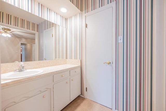 3525 Stanolind Ave, Midland, TX 79707 - bathroom featuring wallpapered walls, vanity, and ceiling fan