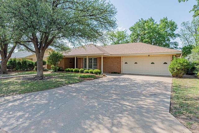 3525 Stanolind Ave, Midland, TX 79707 - ranch-style house featuring concrete driveway, a garage, and brick siding
