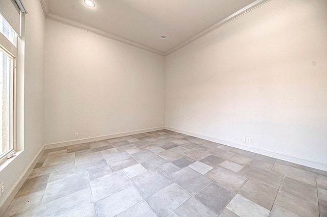 unfurnished room featuring a wealth of natural light and ornamental molding