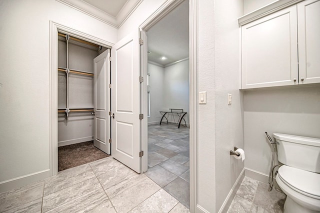 bathroom featuring toilet and ornamental molding