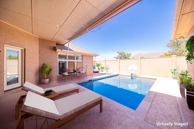 view of pool featuring a patio