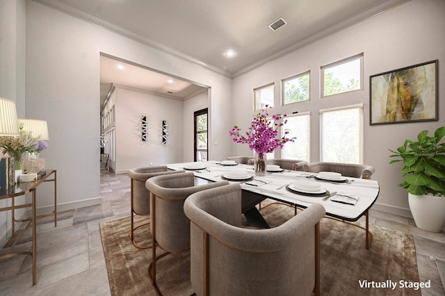 dining space featuring crown molding