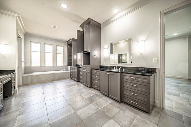 kitchen featuring light tile patterned floors, ornamental molding, and sink