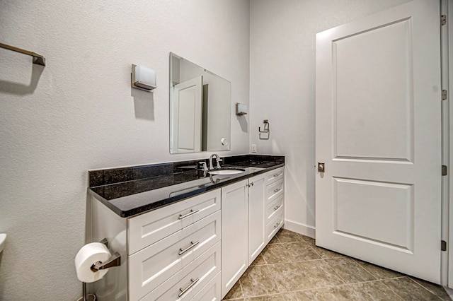 bathroom featuring tile patterned flooring and vanity