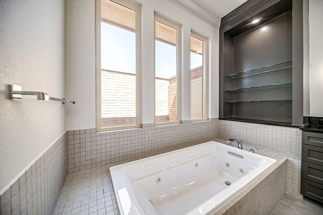 bathroom featuring a relaxing tiled tub, tile walls, and a healthy amount of sunlight