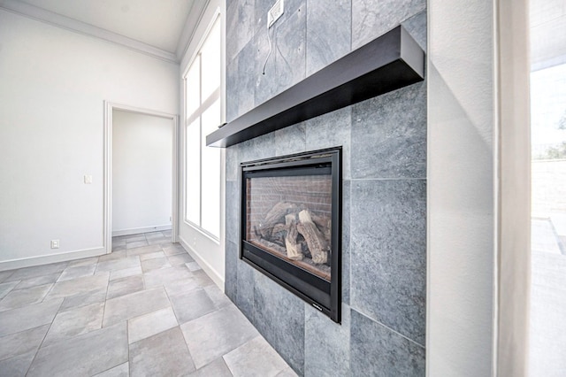 room details featuring ornamental molding and a tile fireplace