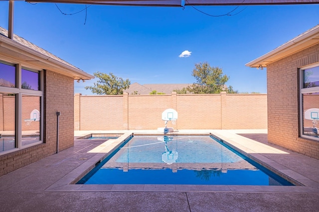 view of pool with an in ground hot tub