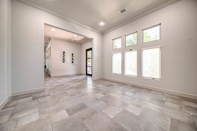 unfurnished room with crown molding