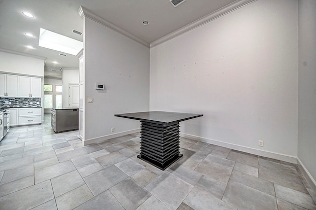 interior space featuring a skylight and ornamental molding