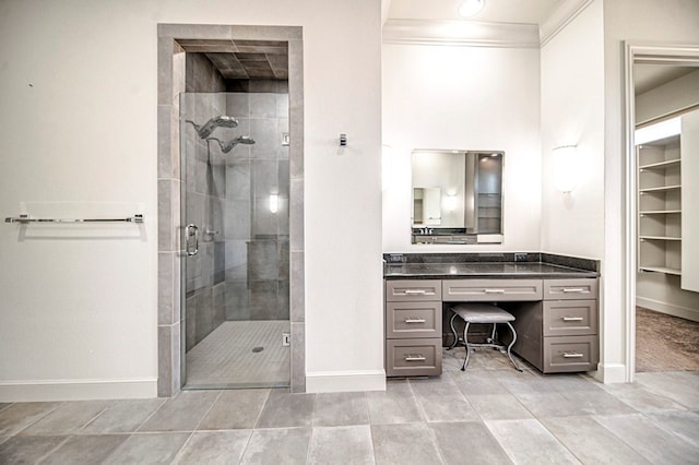 bathroom featuring tile patterned floors, vanity, crown molding, and walk in shower