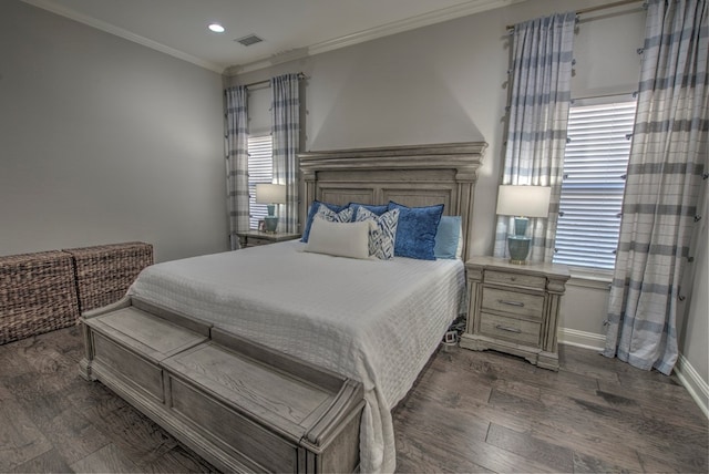 bedroom with crown molding, recessed lighting, visible vents, wood finished floors, and baseboards