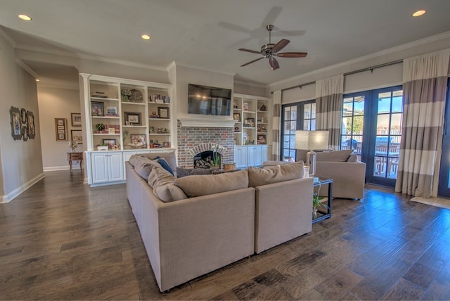 living area featuring dark wood-style flooring, crown molding, recessed lighting, a brick fireplace, and baseboards