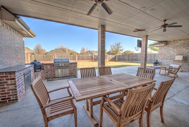 view of patio featuring outdoor dining area, a fenced backyard, and grilling area