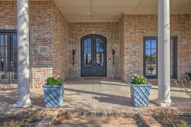 property entrance featuring brick siding