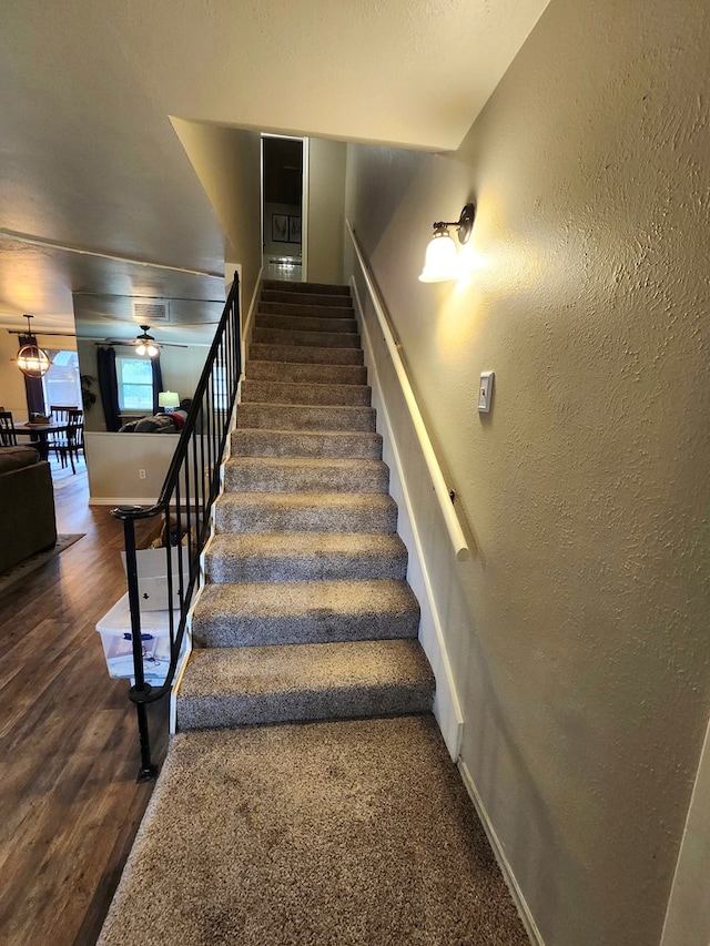 501 W Scharbauer Dr Unit 30, Midland, TX 79705 - stairs with baseboards, wood finished floors, a textured wall, and a ceiling fan
