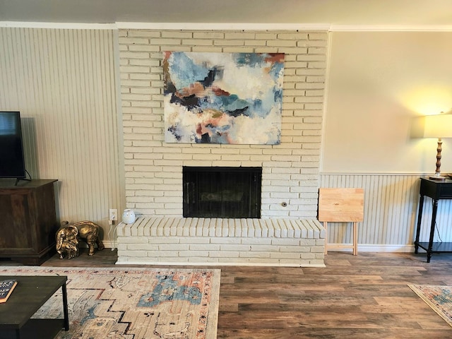 501 W Scharbauer Dr Unit 30, Midland, TX 79705 - living area with a wainscoted wall, crown molding, a fireplace, and wood finished floors