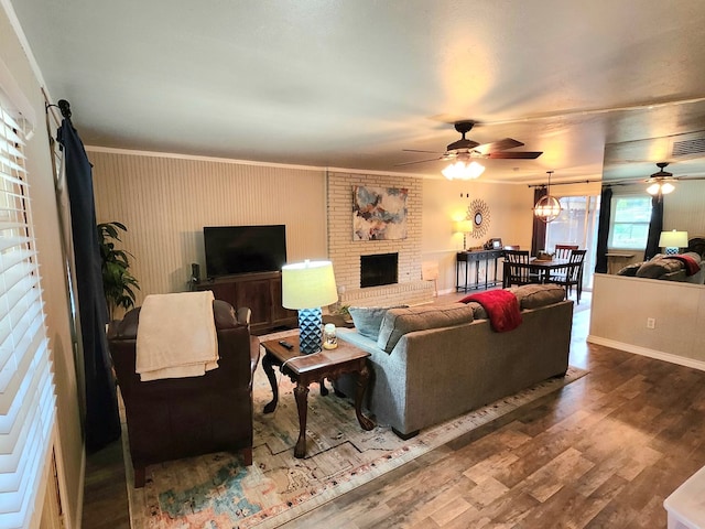 501 W Scharbauer Dr Unit 30, Midland, TX 79705 - living room with visible vents, a fireplace, ceiling fan, wood finished floors, and ornamental molding