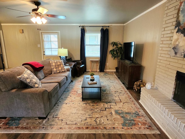 501 W Scharbauer Dr Unit 30, Midland, TX 79705 - living room featuring ceiling fan, wood finished floors, a brick fireplace, and ornamental molding