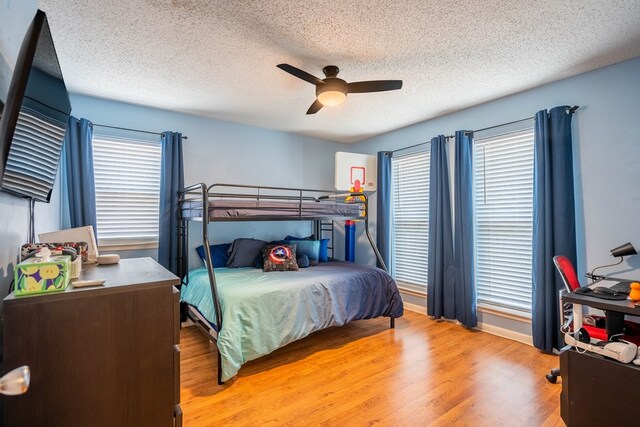 3702 W Michigan Ave, Midland, TX 79703 - bedroom with wood finished floors, a textured ceiling, and ceiling fan