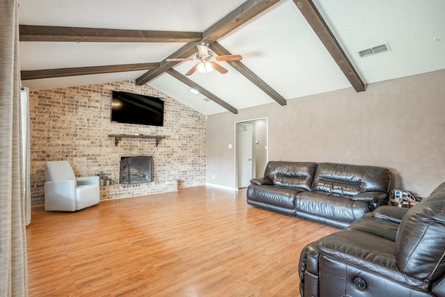 3702 W Michigan Ave, Midland, TX 79703 - living room with ceiling fan, wood finished floors, a fireplace, and brick wall