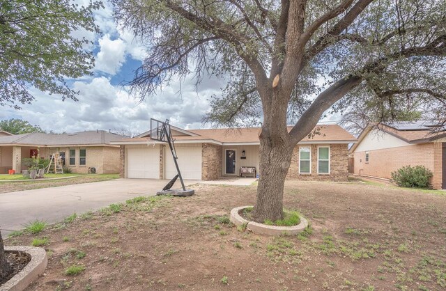 3702 W Michigan Ave, Midland, TX 79703 - single story home featuring a garage, concrete driveway, and brick siding