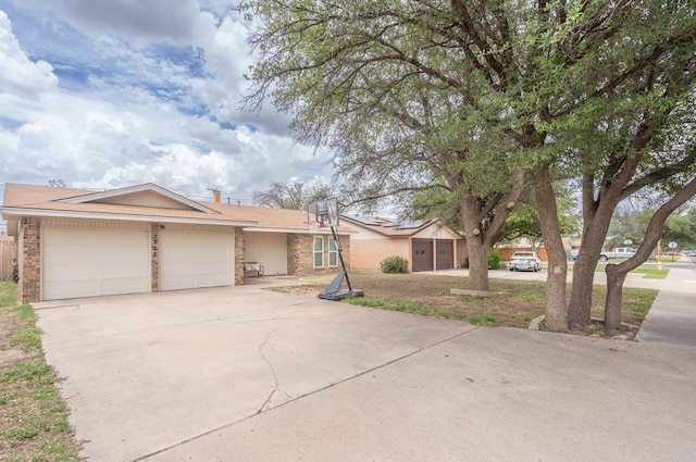 3702 W Michigan Ave, Midland, TX 79703 - view of front of house with a garage, driveway, and brick siding