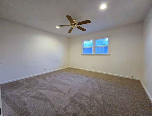 empty room featuring ceiling fan, carpet floors, and a textured ceiling