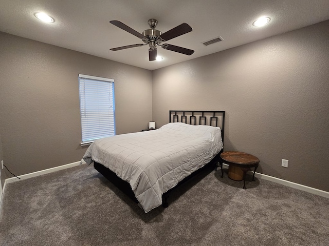 bedroom featuring ceiling fan and dark carpet