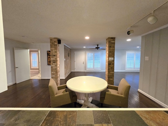 dining room with ornate columns, ceiling fan, and a textured ceiling