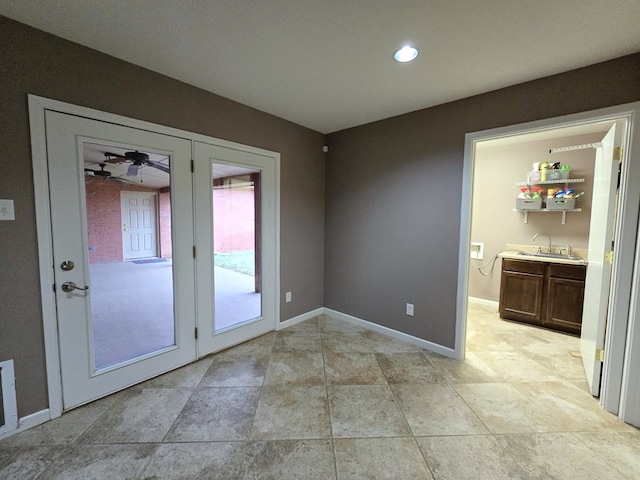 unfurnished room with sink and french doors