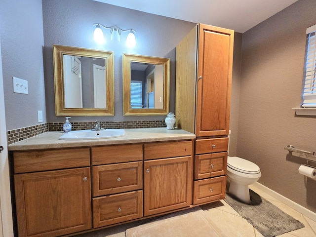 bathroom with tile patterned floors, vanity, toilet, and backsplash