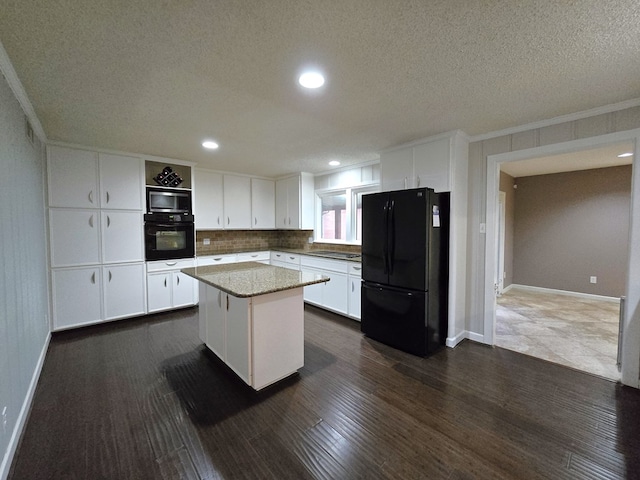 kitchen with tasteful backsplash, ornamental molding, black appliances, white cabinets, and a center island