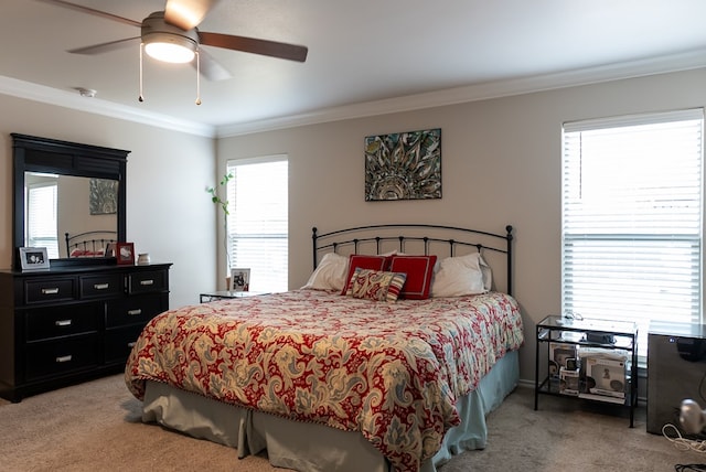 bedroom featuring ceiling fan, ornamental molding, and carpet flooring