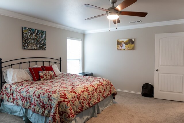 carpeted bedroom featuring ornamental molding and ceiling fan